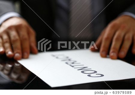 Man in suit and tie hold in arms contract Man in suit and tie hold in arms contract 63979389
