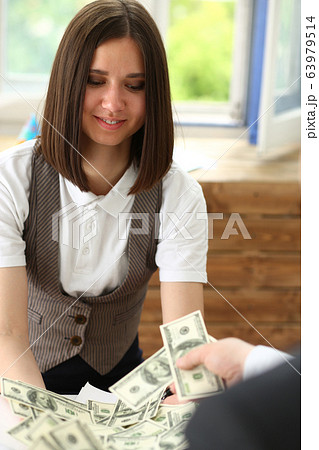 Businessman and business woman counting cash on the table at the office with hands very many dollars salary for the near future Businessman and business woman counting cash on the table at the office with hands very many dollars salary for the near future 63979514