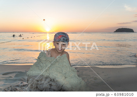 A boy wearing a turban playing in the sand A boy wearing a turban playing in the sand 63981010