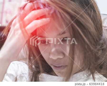 Woman is feeling sick Fever and Headache possibly 63984418