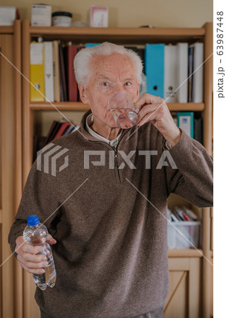 Portrait elderly man drinking water 63987448