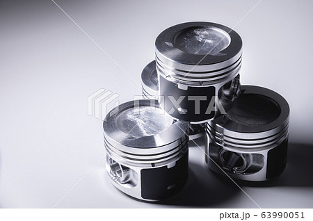 New parts for the internal combustion engine. Pistons on a gray gradient background New parts for the internal combustion engine. Pistons on a gray gradient background 63990051