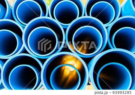 PVC pipes stacked in construction site 63993285