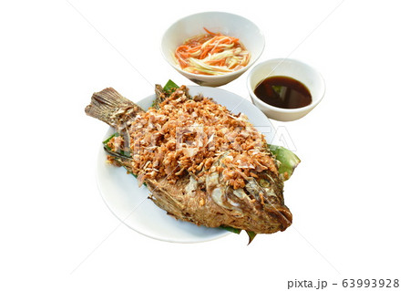 batter fried mango fish topping chop garlic dipping sweet and soy sauce  63993928