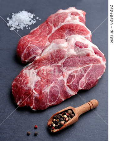 Crude meat on black board. Crude meat on black board. 63994392