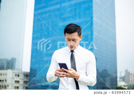 man worry while looking smartphone man worry while looking smartphone 63994573