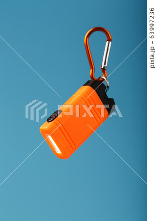 Orange led Flashlight with a carabiner on a blue 63997236