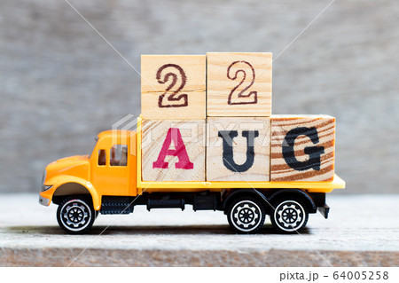 Truck hold letter block in word 22aug on wood background  64005258