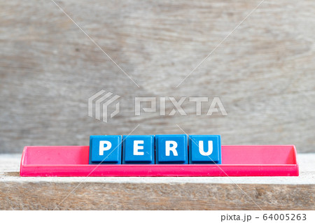 Tile letter on red rack in word peru on wood background  64005263