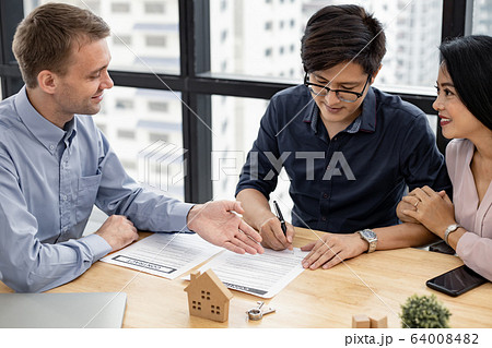 Couple in transaction signing contract of house 64008482