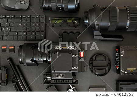 Top View of a Creative Filmmakers Office Desk with Lined up Camera and Gear 64012555