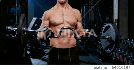 Incognito sportsman training biceps with barbell. 64016194