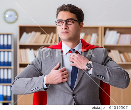 Superhero businessman working in the office 64016507