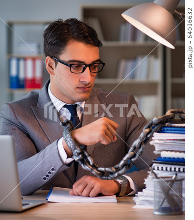 Businessman staying in the office for long hours Businessman staying in the office for long hours 64016632