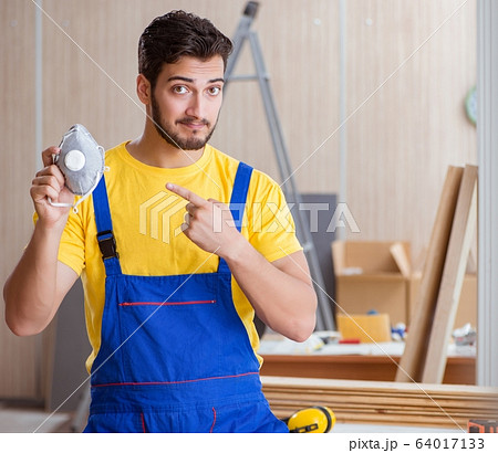 Young repairman carpenter working cutting wood 64017133