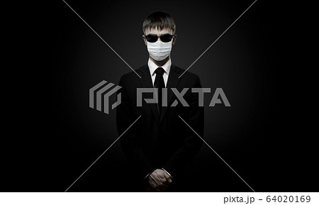 man in black costume in medical mask man in black costume in medical mask 64020169