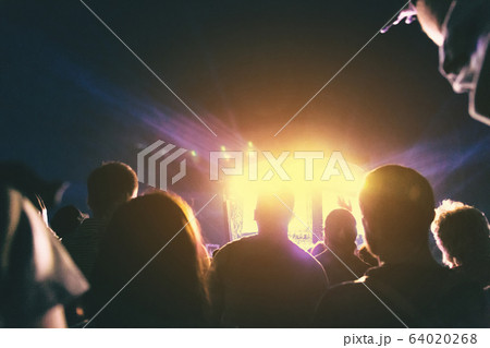 Crowd of spectators having fun at a concert. 64020268