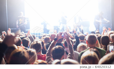 The audience watching the concert on stage. The audience watching the concert on stage. 64020312