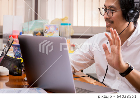 Businessman making video conference using laptop work from home. 64023551