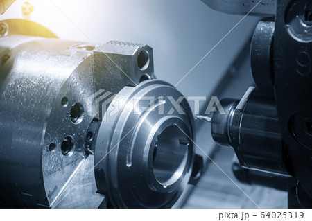 The CNC lathe machine in metal working process. The CNC lathe machine in metal working process. 64025319