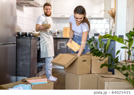 married couple in new kitchen, after moving married couple in new kitchen, after moving 64025435