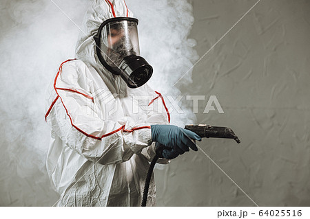 male in protective hazmat suit disinfect public isolated spaces 64025516