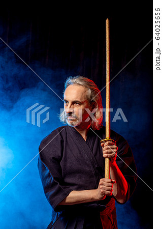 portrait of male kendo fighter with bokuto. protection concept 64025656
