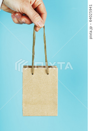 Small paper Bag at arm's length, brown craft bag Small paper Bag at arm's length, brown craft bag 64025941
