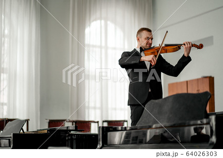 young caucasian violinist play classical instrument 64026303