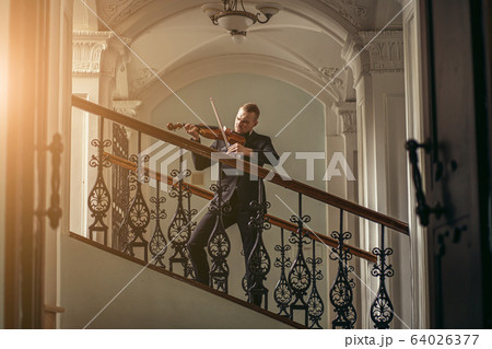 talented gorgeous man play violin 64026377