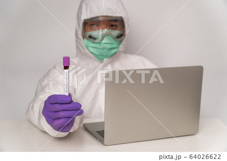 Doctors in the protective suits and masks are Doctors in the protective suits and masks are 64026622