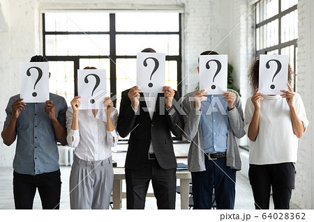 Business people hiding faces behind papers sheets with question marks. Business people hiding faces behind papers sheets with question marks. 64028362