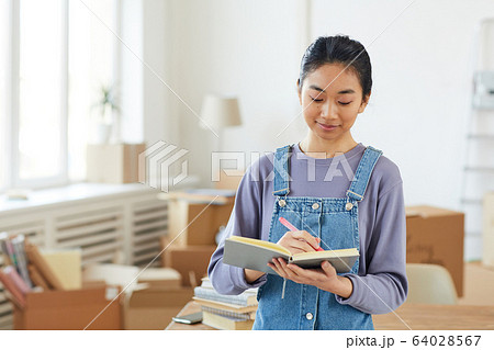 Happy Asian Woman Planning Moving to New House Happy Asian Woman Planning Moving to New House 64028567