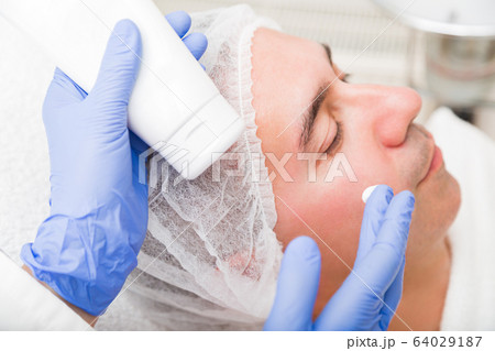 Anti-aging cosmetic mask applying for adult man 64029187