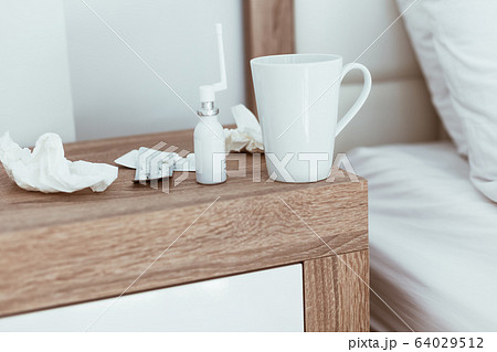 Medicines and pills bedside table illness symptoms 64029512