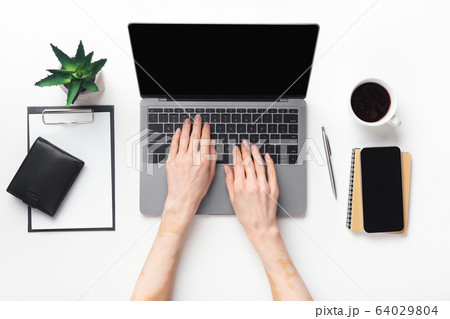 Closeup top view of woman working on laptop 64029804