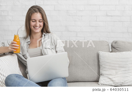 Young woman freelancer have good mood because drinking detox cocktails every day 64030511
