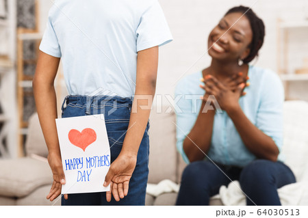Afro kid congratulating mom with handmade card Afro kid congratulating mom with handmade card 64030513