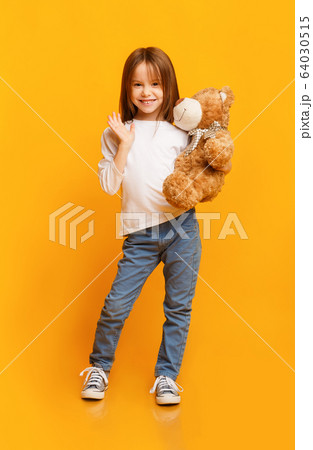 Smiling beautiful girl holding big toy teddy bear Smiling beautiful girl holding big toy teddy bear 64030515