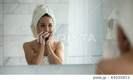 Smiling young female touch healthy face skin Smiling young female touch healthy face skin 64030853