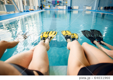 Female group at the poolside, feet in flippers Female group at the poolside, feet in flippers 64031960