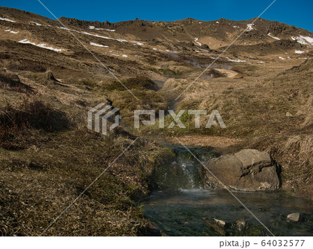 Steaming thermal water in the mountains of Iceland Steaming thermal water in the mountains of Iceland 64032577