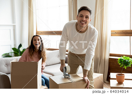 Excited young family couple preparing things stuff for delivery. Excited young family couple preparing things stuff for delivery. 64034014