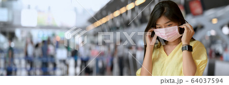 Close up view of a woman wearing mask when going Close up view of a woman wearing mask when going 64037594
