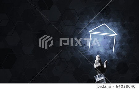 Conceptual image with hand pointing at house or main page icon o 64038040