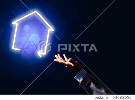 Conceptual image with hand pointing at house or main page icon on dark background Conceptual image with hand pointing at house or main page icon on dark background 64038050