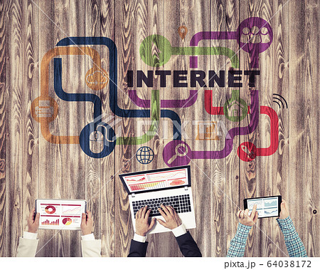 Top view of businesspeople sitting at table and using gadgets 64038172