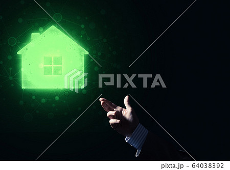 Conceptual image with hand pointing at house or main page icon on dark background 64038392