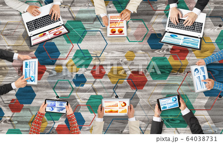 Top view of businesspeople sitting at table and using gadgets 64038731