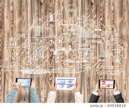 Top view of businesspeople sitting at table and using gadgets Top view of businesspeople sitting at table and using gadgets 64038816